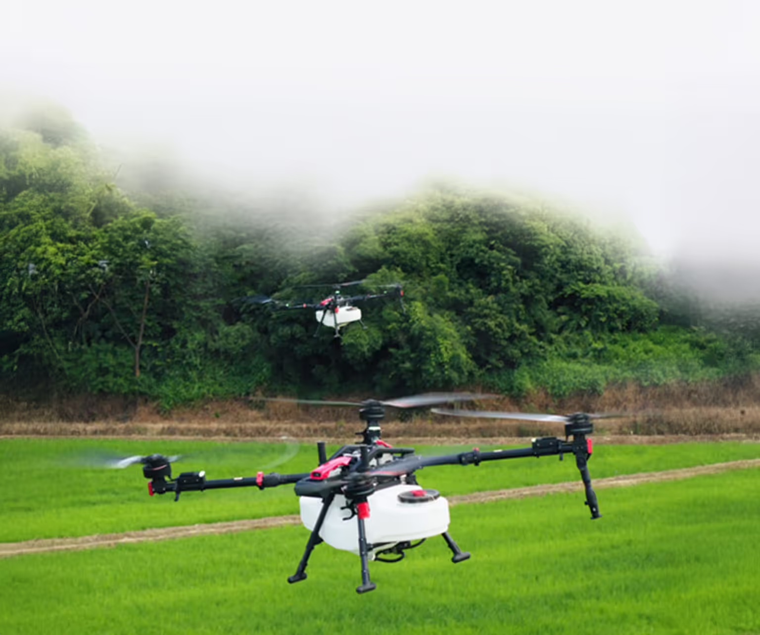 Several XAG P150 Max drones operating together in swarm mode over farmland